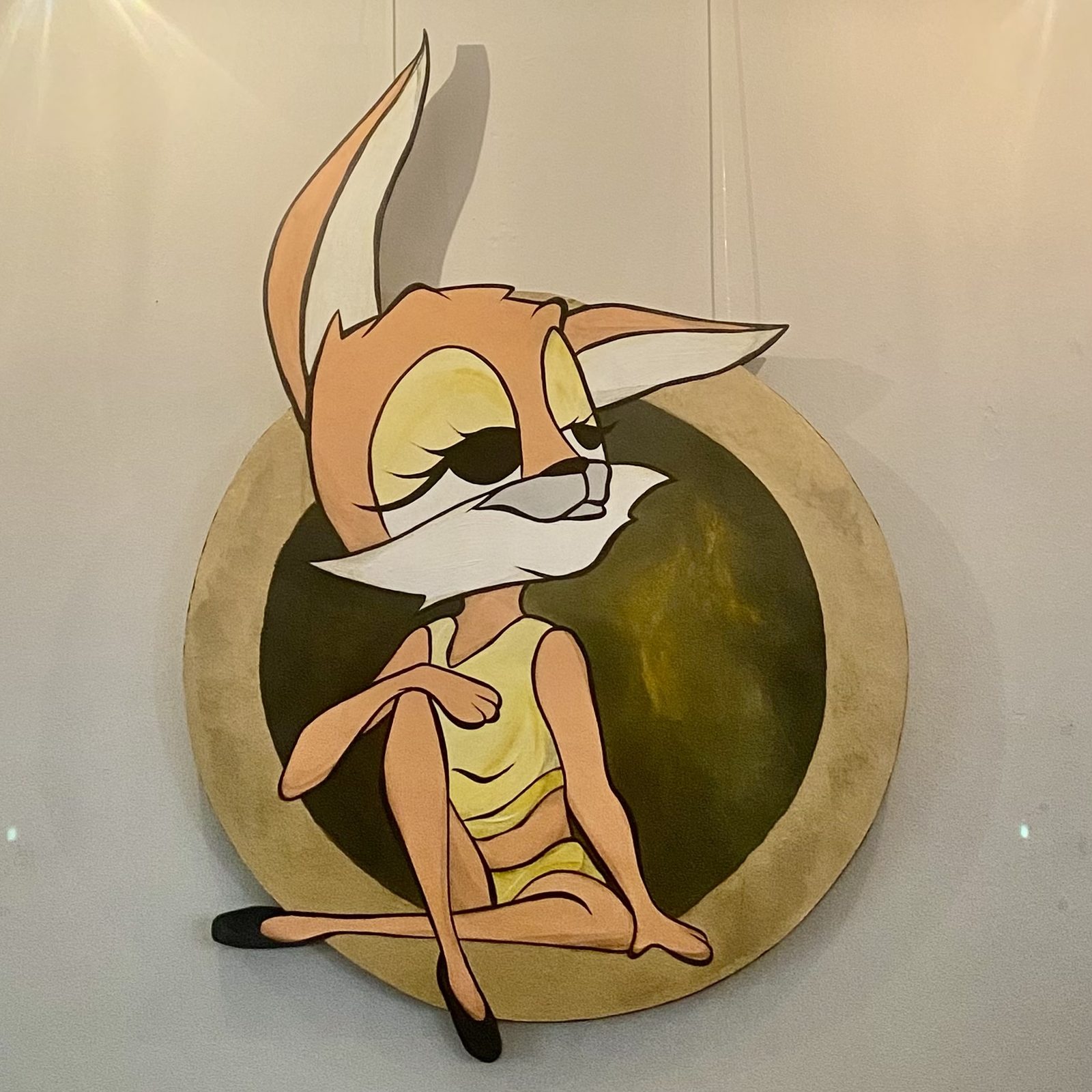 Acrylic painting on a circular cutout wooden board, the female fox character sitting comfortably, her ears and legs extending beyond the circle edge. Faye by Dared, Woman Portrait Gallery.
