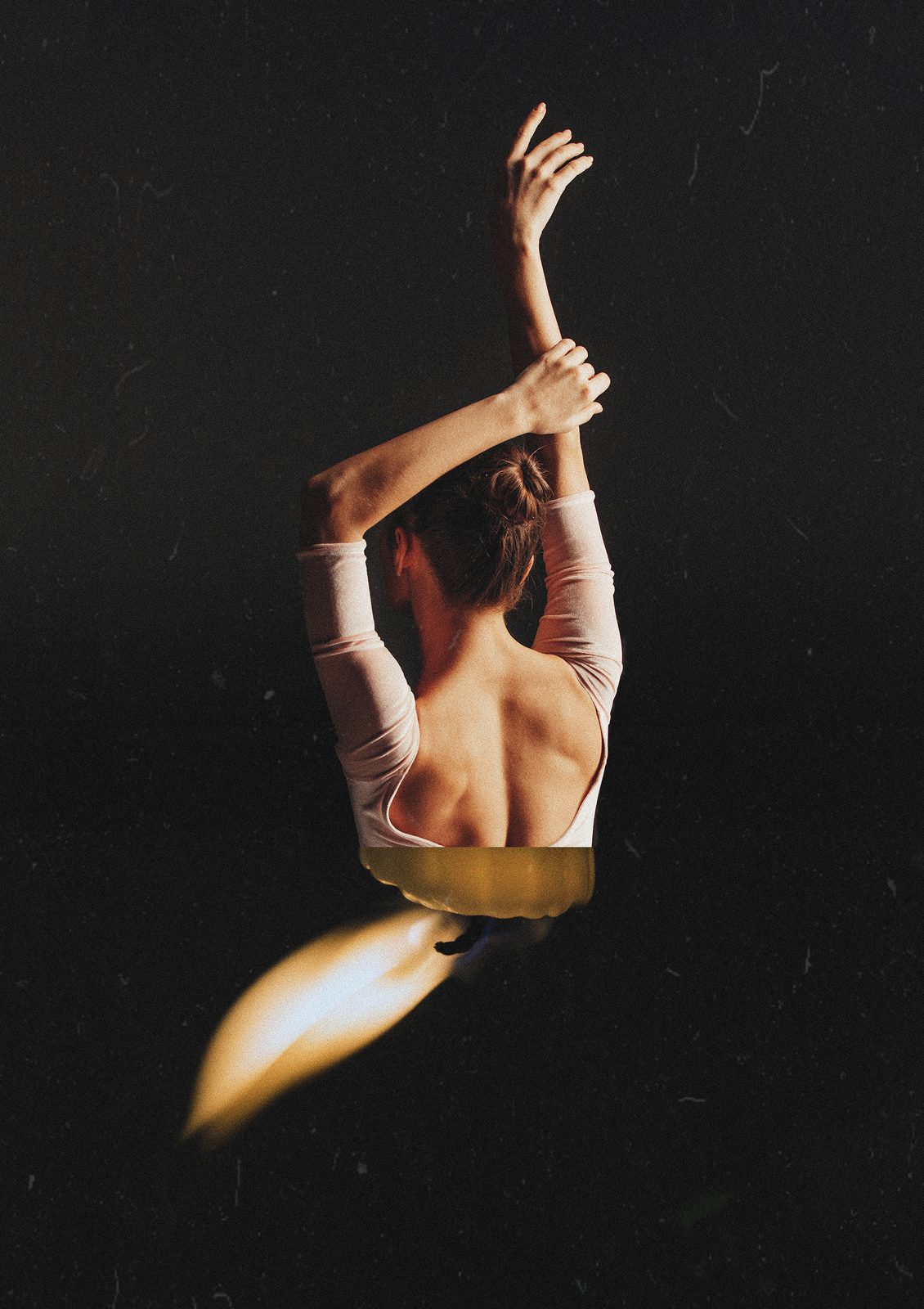 Digital collage on black background, a ballet dancer with raised arm merged with an inverted candle flame, the two forms composited into a single seamless silhouette. Dancing in the dark by Nina Barnini, Woman Portrait Gallery.